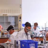 students interacting during a chemistry experiment